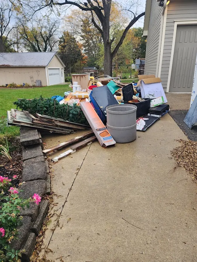 Dumpster being loaded with debris for Commercial Dumpster Rental in Welch